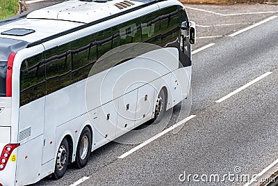 White bus coach on uk motorway in fast motion Stock Photo