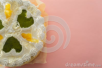 White cake on a colored background with ribbons shot from above Stock Photo