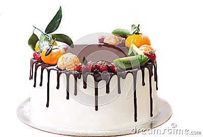 White cake drenched in chocolate and decorated with berries on an isolated white background. Stock Photo