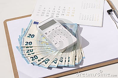 White calculator, calendar, and euro on the office desk. The concept of planning in business Stock Photo