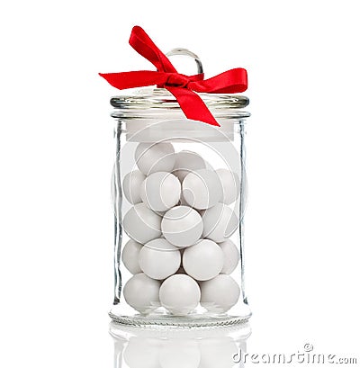 White candies, Gumballs in glass jar Stock Photo