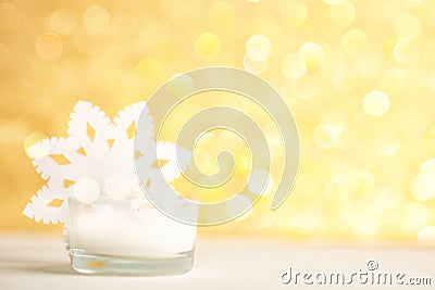 White candle and snowflake on golden bokeh background Stock Photo