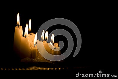 White candles burning in the dark Stock Photo