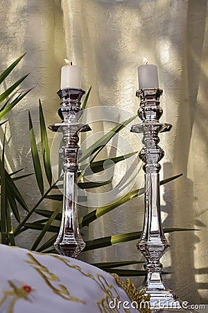 White candles burning on silver candlesticks for shabbat Stock Photo