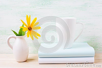 White cappuccino mug mockup with yellow rosinweed flowers in pit Stock Photo