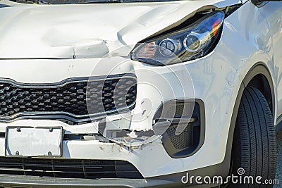 White car with damaged front bumper from a collison or crash in the city or on the streets in an urban area Stock Photo