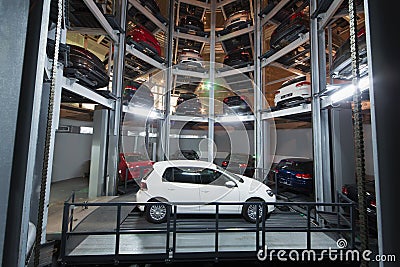 The white car on parking lot with automated car parking system Stock Photo