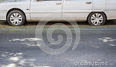 White car with two tire burst. Stock Photo