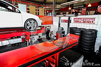 White car in a workshop of the Tyre repair and wheel alignment Centre of Johannesburg, South Africa Editorial Stock Photo