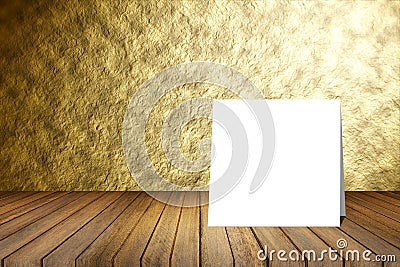 White card put on wooden desk or wooden floor on blurred abstract gold wall texture background.use for present or mock up Stock Photo