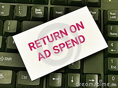 White card with text return on ad spend on computer keyboard. Stock Photo