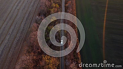 White cargo truck driving dirt road between agricultural fields countryside. Stock Photo