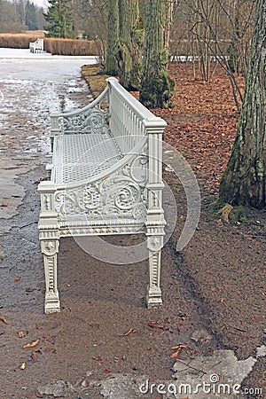 White cast-iron bench in the park Stock Photo