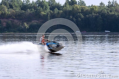 White, Caucasian attractive man on a blue water motorcycle Editorial Stock Photo