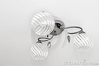 White ceiling chandelier with three round glass plafonds Stock Photo