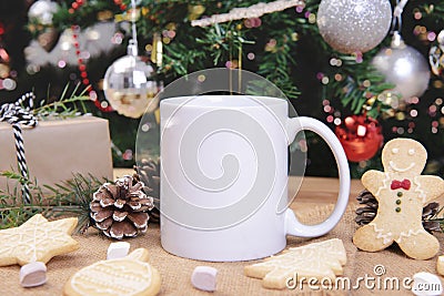 White ceramic coffee cup and christmas decoration on woon table background. mockup for creative advertising text message or Stock Photo