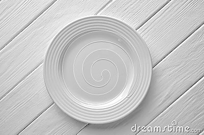 White ceramic plate close-up on painted wood background Stock Photo