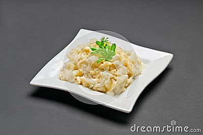 White ceramic plate with fresh apples, pineapple, celery and mayonnaise salad Stock Photo