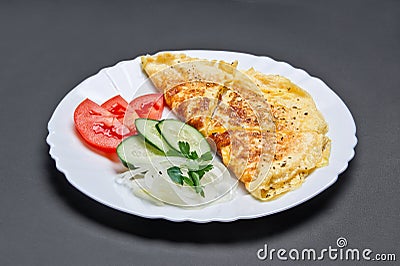 White ceramic plate with omelette and fresh tomatoes and cucumbers Stock Photo