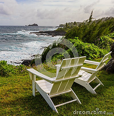 White Chairs Overlooking The Rugged Shore of Kaihalulu Bay Stock Photo