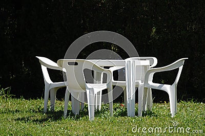 White chairs and table in lawn Stock Photo