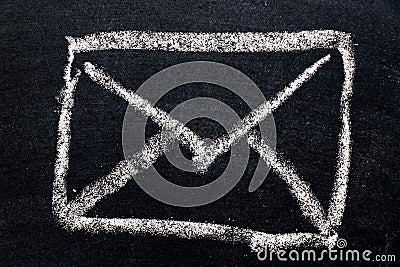White chalk drawing in mail envelope icon on black board Stock Photo