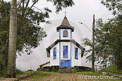 Colonial chapel framed by trees and foggy background, Catas Altas, Minas Gerais, Brazil Stock Photo