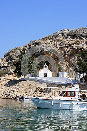 White chapel with boat in Rhodes Stock Photo