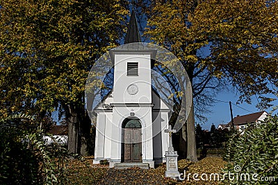 White chapel between the colored leaves Stock Photo