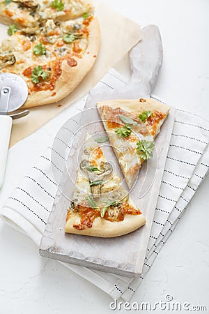 White cheese pizza with artichoke and arugula Stock Photo