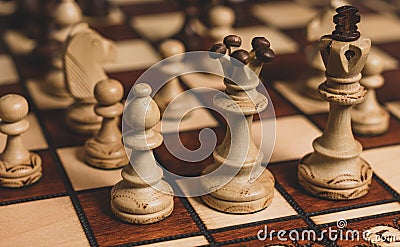 White chess bishop, queen and king protected by pawns Stock Photo