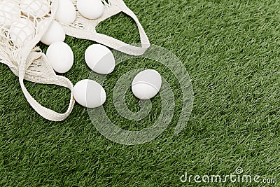 white chicken eggs lie on a green lawn bags vintage top view Stock Photo