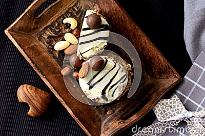 White chocolate and nuts keto dessert on rustic tray Stock Photo