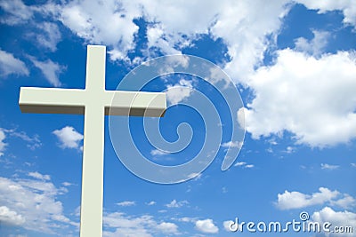 White Christian cross in front of a cloudy sky Stock Photo