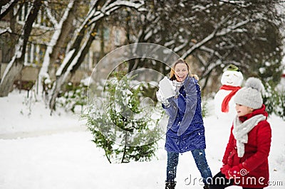 White Christmas. Girl plays with mother in snowballs in the winter park. Stock Photo