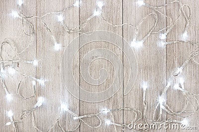 White Christmas lights frame over light gray wood Stock Photo