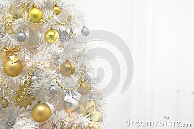 White christmas tree with gold decoration on white background Stock Photo