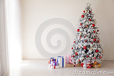 White Christmas tree with red toys new year winter gifts decor Stock Photo