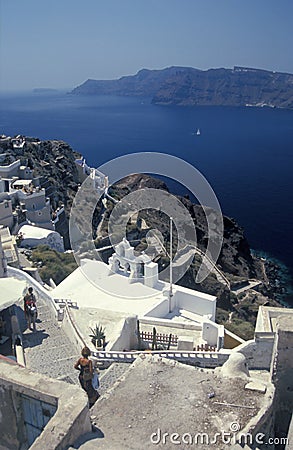 White church with clocktowers and houses in Oia on volcanic island of Santorini Stock Photo