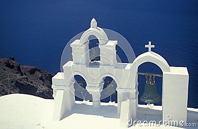 White church with clocktowers in Oia on volcanic island of Santorini Stock Photo