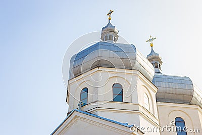 White church on sunny day. Ortodox cathedral on clear blue sky background. Religious architecture. Faith and pray concept. Stock Photo