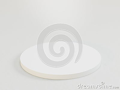 A white circular object with a foam or sponge-like center sits on a flat surface The outer border has a slight indent Stock Photo