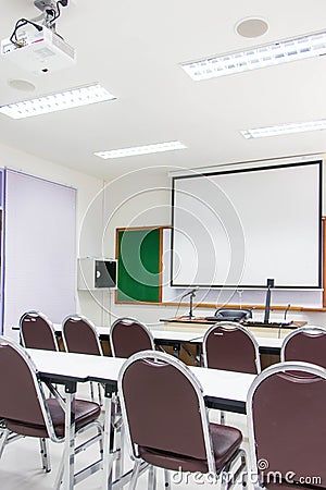 White classrooms are currently available with student desks and chairs Stock Photo