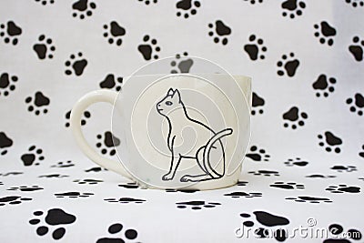 White clay mug with the Egyptian hieroglyph Cat. Handmade. Decor engobe, covered with transparent glaze, two firing Stock Photo