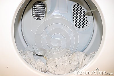 White clothes sitting in open close dryer Stock Photo