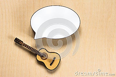 White cloud for text and and toy guitar on wooden background Stock Photo