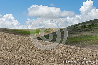 White clouds above rolling farm Stock Photo