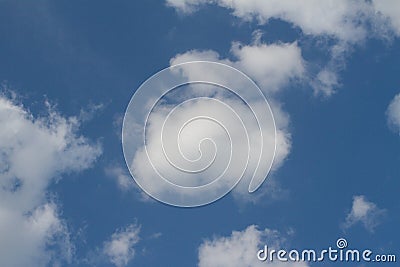 White clouds over sunny pollution free blue sky Stock Photo