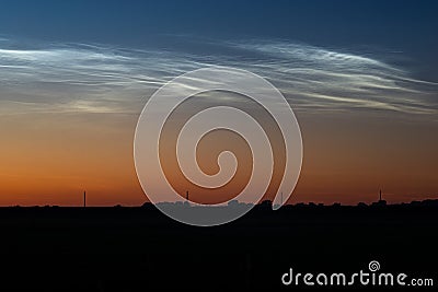 White clouds shining in the northern sky at night Stock Photo