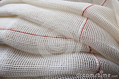 White coarse cotton or linen curtains made of weaves of thin threads. Simple compact economical apartment interior Stock Photo